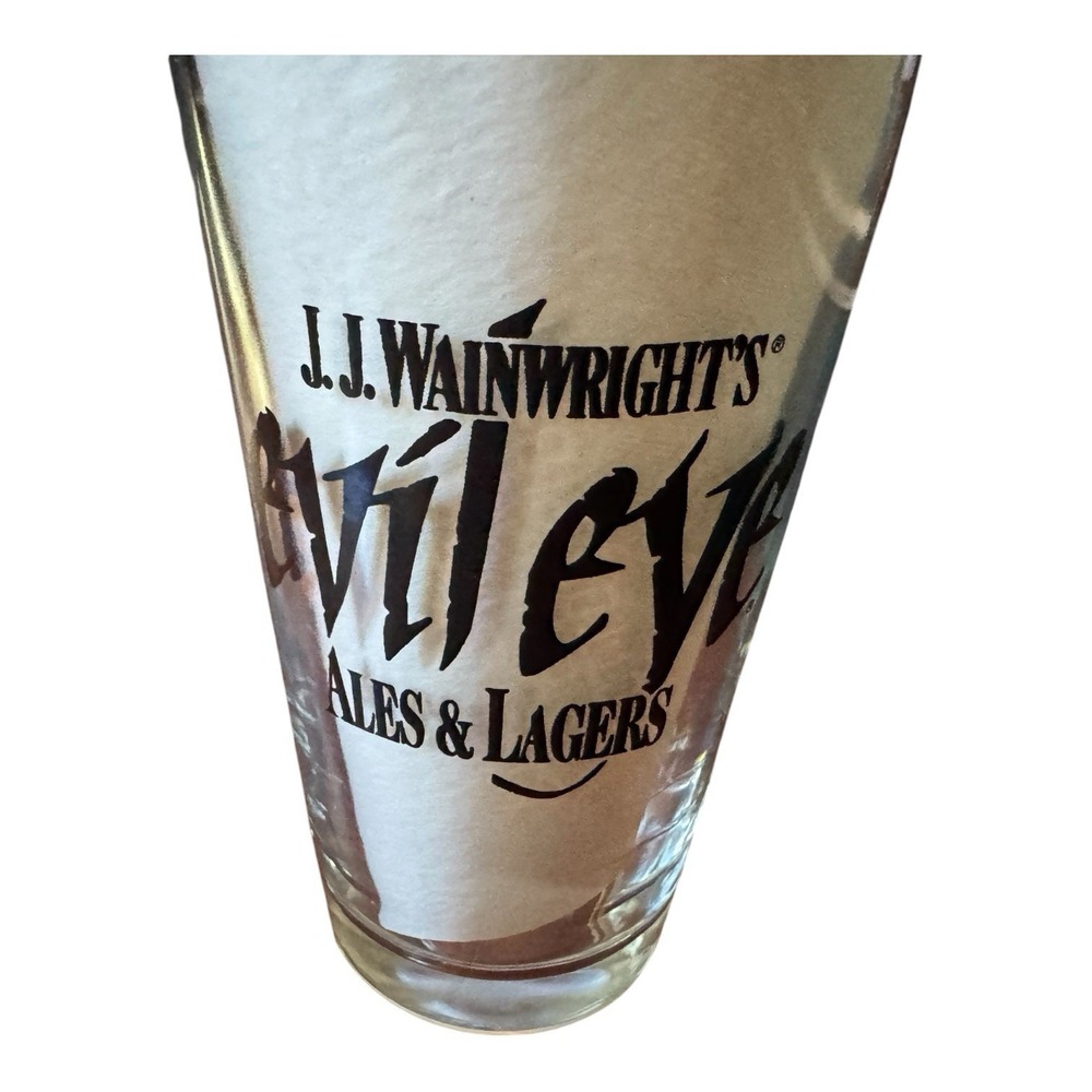 JJ Wainwrights Evil Eye Ales & Lagers Beer Pint Glass Vintage Black Logo Barware